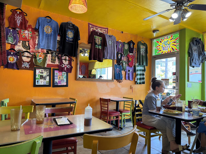 Cafe Rae's dining room, hung with handcrafted batik textiles and bright mismatched chairs